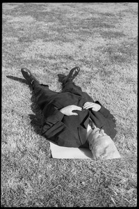 Man lying on the grass during the demonstration: Washington Vietnam March for Peace