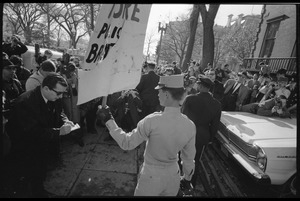 American Nazi Party counter-protester Douglas L. Niles, in uniform, holding up a sign for the crowd: Washington Vietnam March for Peace