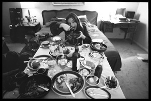 Judy Collins: horsing around after a meal, seated at a dinner table set up in her room at the Beverly Hills Hotel