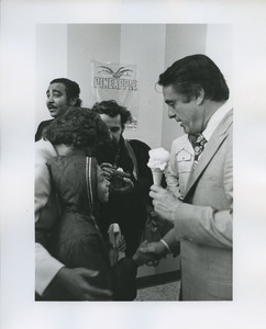 Sargent Shriver shaking hands with child