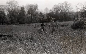 Young woman seated in tall grass
