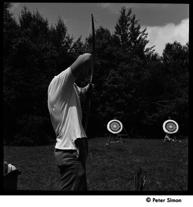 Camp Arcadia: camper shooting at an archery target