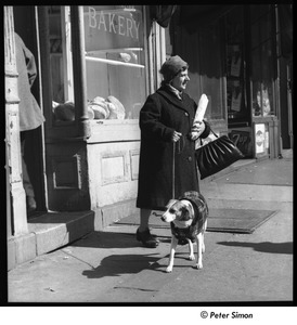 Bowery: woman with dog leaving bakery and holding baguette