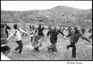 May Day at Packer Corners commune: group holding hands and dancing