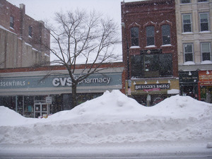 Plowed snow piled high in the middle of Main Street, Northampton, Mass., near intersection with Gothic St.