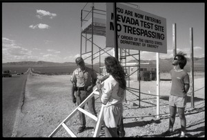 Peace encampment activists talking a security guard at the entrance to the Nevada Test Site