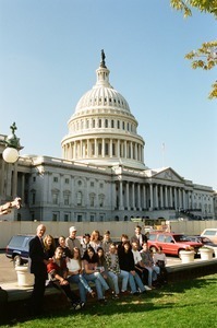 Congressman John W. Olver and group of visitors, posed in front of the United States Capitol building