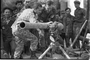 Francois Sully inspecting 75mm recoiler rifle captured from Vietcong; Loc Trang.