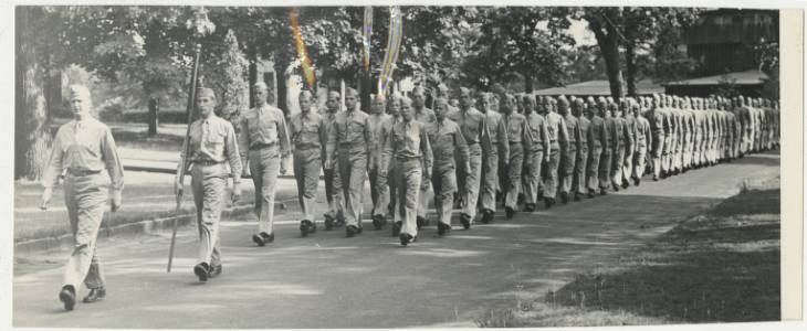 Soldiers marching in a formation on the SpringField college campus (May 1943)