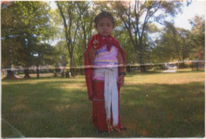 A photograph of Su Meh's daughter in traditional Karenni clothing near Wang Middle School in Lowell, Massachusetts, 2009