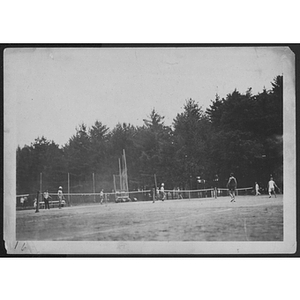 View of tennis courts and people playing