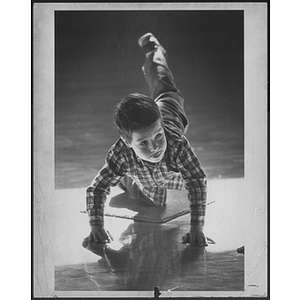 Child playing on gym floor at West Roxbury branch