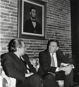 Mayor Raynond L. Flynn with an unidentified man sititng in front of a portrait of Abraham Lincoln
