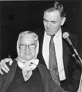 Mayor Raymond L. Flynn at a microphone with an unidentified senior woman