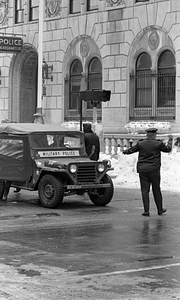 Unidentified officer directing Military Police vehicle in front of Boston Police Headquarters on Berkeley Street