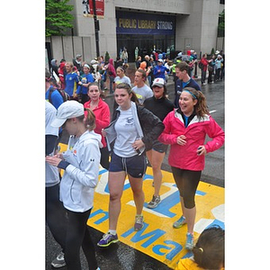 A crowd of One Run participants cross the finish line