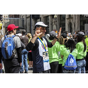 2013 Boston Marathon runner poses after completing the race