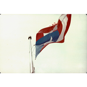 A Puerto Rican flag flies in the sky