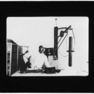 Doctor holding early x-ray machine