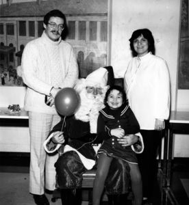 Suffolk University Professor Agnes S. Bain (CAS) and family with Santa at holiday party