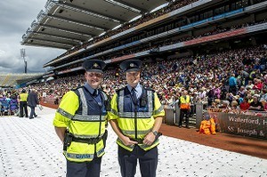 Two Garda (police) in front of a sign for Waterford, at the 2012 50th Eucharistic Congress, Final Day Ceremony, 17th June, at Croke Park GAA Stadium, Dublin