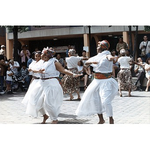 Women performing a traditional dance in the plaza for Festival Betances spectators.