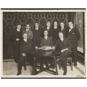 Group portrait of the committee members, including Louis A. Coolidge, seated on the right