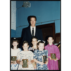 Former Boston Celtic Dave Cowens posing for a group picture with five girls at a Kiwanis Awards Night