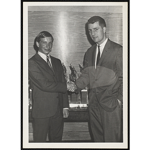 William O. Taylor II, Overseer of the Boys' Clubs of Boston, at right, shaking hands with Francis Davis at a Boys' Club sports awards event