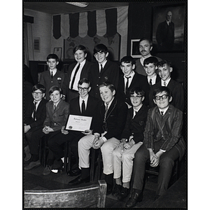 Adult Advisor James Munn and twelve boys from the Keystone Club of the Boys' Clubs of Boston posing with a certificate
