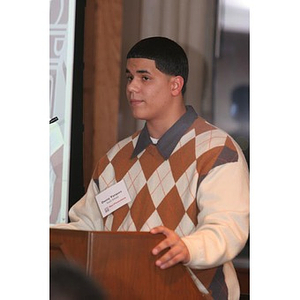 Danny Vazquez stands at the podium at a Torch Scholars event