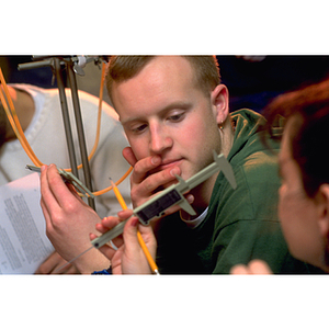 A student taking measurement during an engineering class