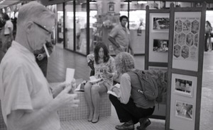 Commune member hawking the magazine in an indoor shopping mall