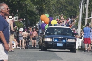 Police escort leading the approaching parade : Provincetown Carnival parade