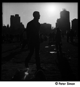 Young man, back lit, at the Be-In, Central Park, New York City