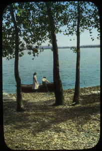 Boy and girl with rowboat at water's edge