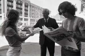 Boston Phoenix promotional photos: Phoenix hawker handing paper to man, Stephen Davis (r) reading