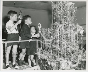 Young clients decorating Christmas tree