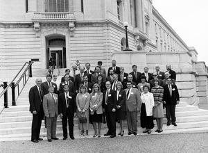 Congressman John W. Olver (left) with group of visitors from Massachusetts corporations, posed on the steps of the United States Capitol building