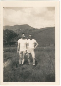 Two men in shorts and t-shirts in a field