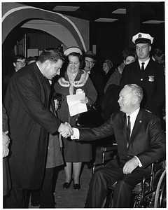 Unidentified man shaking hands with Mayor John F. Collins