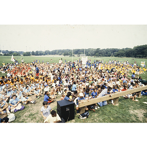Crowd of children sitting on a sports field at Reading YMCA Summer Camp