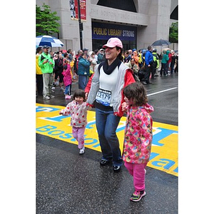 Woman crosses One Run finish line with daughters