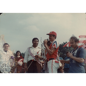 A man speaks into a microphone next to the Mariscal at the Festival Puertorriqueño