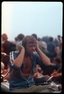 Man in the audience covering his ears at the Woodstock Festival