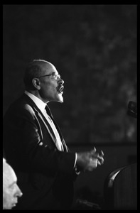 Isaac Deutscher, speaking at the National Teach-in on the Vietnam War: half-length portrait, standing at the podium, from stage right