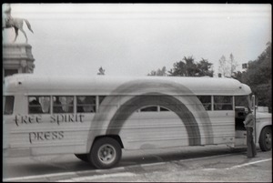 Free Spirit Press bus driving past an equestrian statue