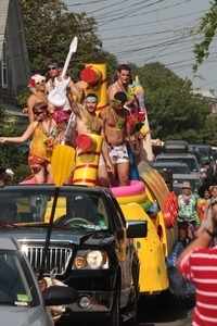 Parade marchers in a large kiddie pool on top of a float : Provincetown Carnival parade