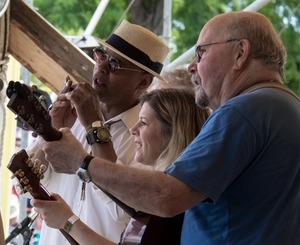 Guy Davis (harmonica), Dar Williams (guitar), and Tom Paxton (guitar) (from left) performing on the Rainbow stage at the Clearwater Festival