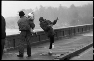 Judy Salonia, her husband Vincent, and daughter Ashley (4) dodge the spray at the Narragansett seawall